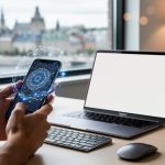 Hands holding a smartphone at a Quebec City remote-work desk with an abstract AI glow linking to global opportunities over a laptop.